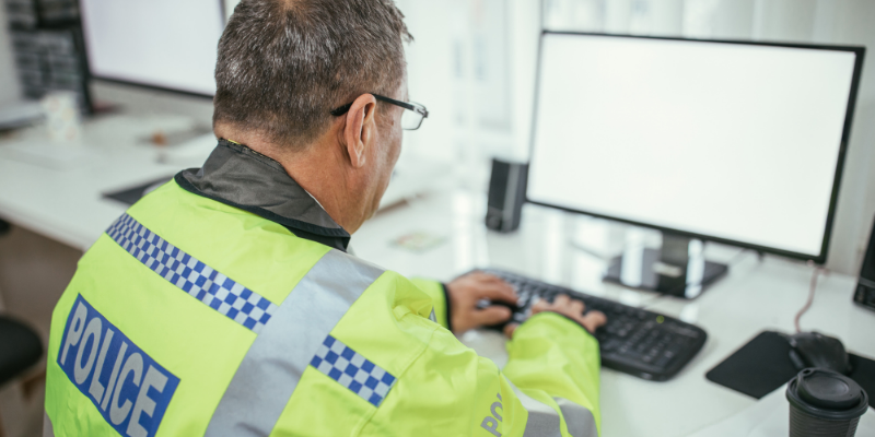 Police Man on computer